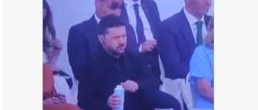 Zelenski a fost surprins la parada de Ziua Franţei în timp ce rupe capacul de la sticla de plastic, ignorând normele UE. Internauţii se amuză: „A amânat aderarea Ucrainei cu 15 ani” – VIDEO